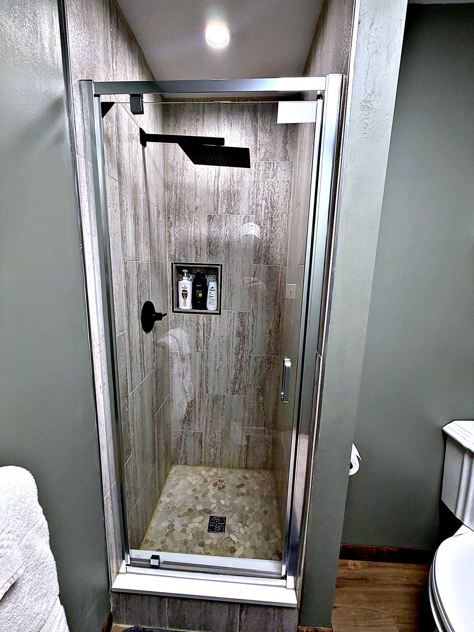 Glass-door walk-in shower in modern bathroom