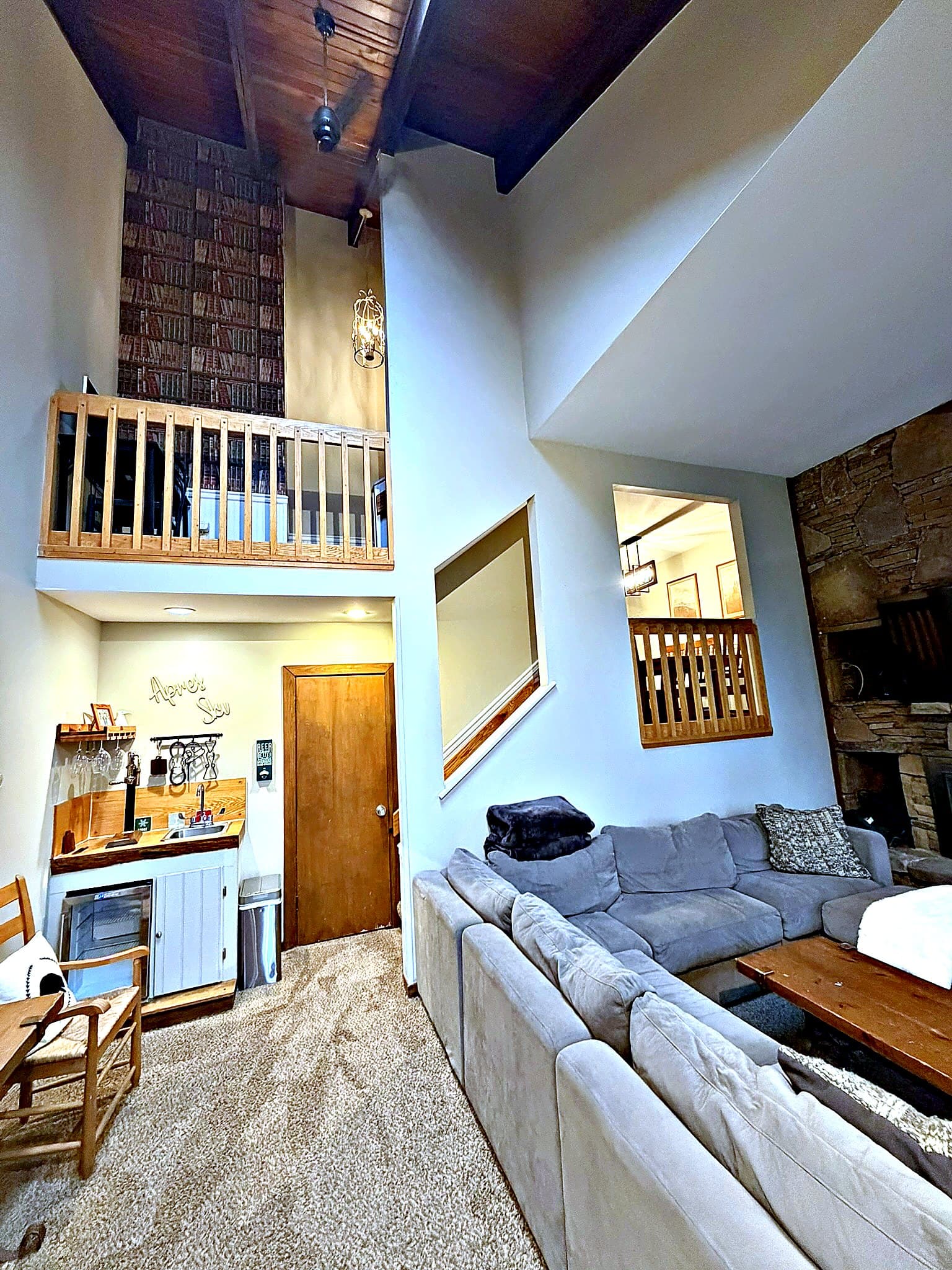 Vaulted living area looking up to library loft